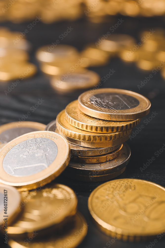 Golden coins on dark wooden background Golden coins on dark wooden background