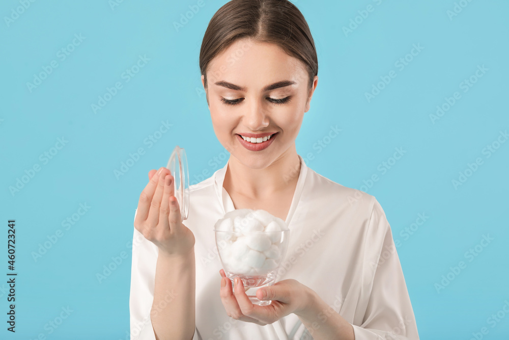 Beautiful young woman with cotton wool on color background Beautiful young woman with cotton wool on color background