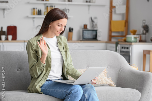 Free Download Young woman with laptop video chatting at home - GFXLoad