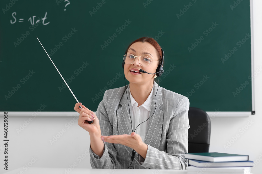 Teacher conducting lesson online in classroom Teacher conducting lesson online in classroom