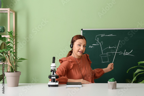 Teacher conducting biology lesson online in classroom