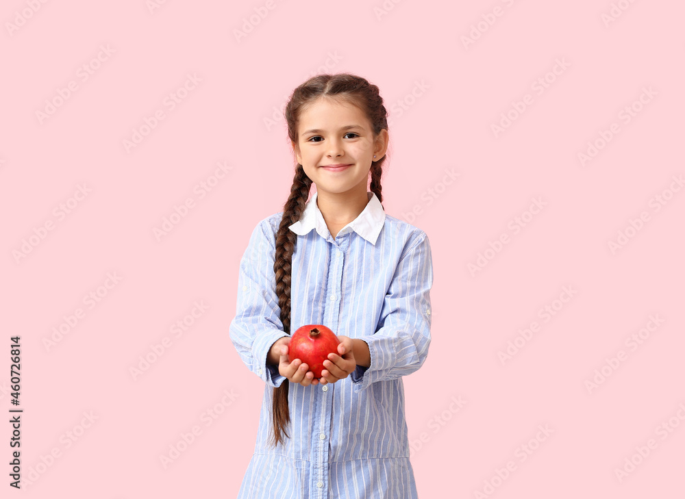 Little girl with pomegranate on color background Little girl with pomegranate on color background