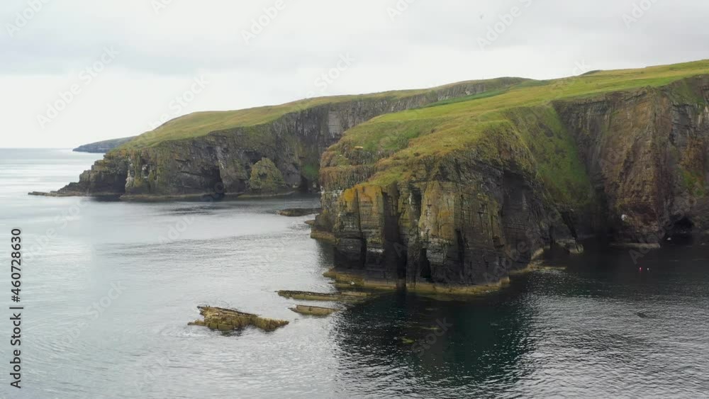 Drone shot of Whaligoe Haven, the 250ft cliffs and rock walls overlooking the north sea in Scotland Drone shot of Whaligoe Haven, the 250ft cliffs and rock walls overlooking the north sea in Scotland