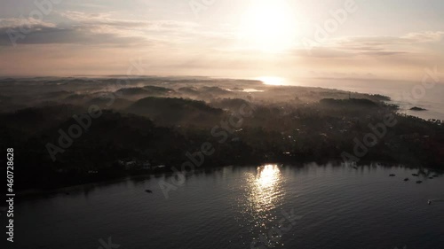 Wallpaper Mural Welagama Bay during sunrise. Aerial cinematic view of the coast of Weligama, Sri Lanka. during foggy sunrise. Indian ocean, mist, sun rays, sun reflection, sunrise. SouthEast Asi Torontodigital.ca