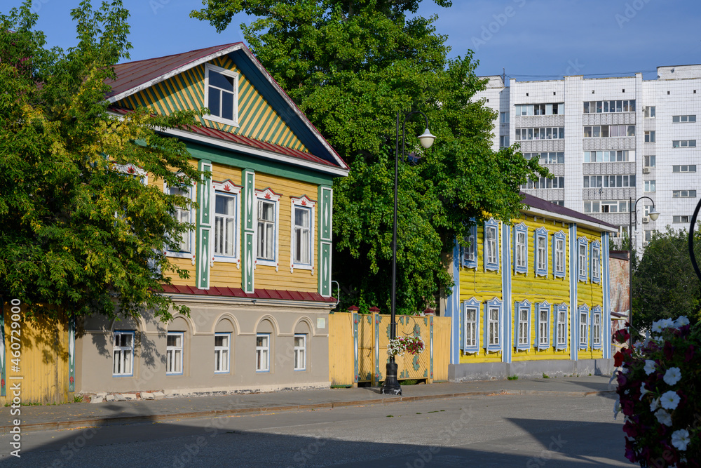 Naklejka premium City street with an old wooden house in national style in Kazan, Russia, early in the morning
