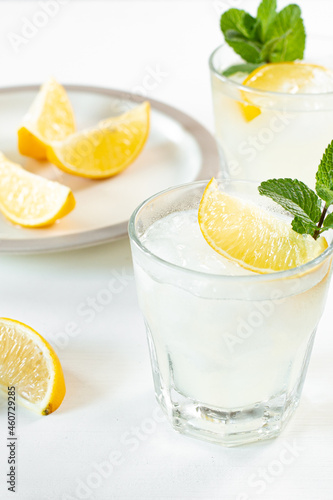 Fresh squeezed lemon juice chilled over ice with sweet lemon wedges and fresh picked sprig of mint. 