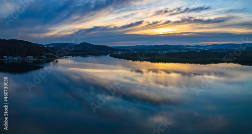 Sunrise and cloud reflections panorama waterscape