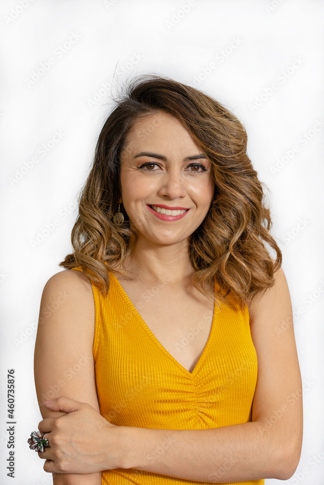 Young woman smiling standing casually dressed in yellow blouse isolated on white background Young woman smiling standing casually dressed in yellow blouse isolated on white background