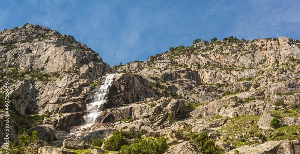 Fascinating view of a waterfall falling from mountains at Shahi bagh, Swat Valley, Pakistan with plants on the mountains. Fascinating view of a waterfall falling from mountains at Shahi bagh, Swat Valley, Pakistan with plants on the mountains.