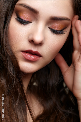 Beauty portrait of young woman. Brunette girl with evening female makeup.