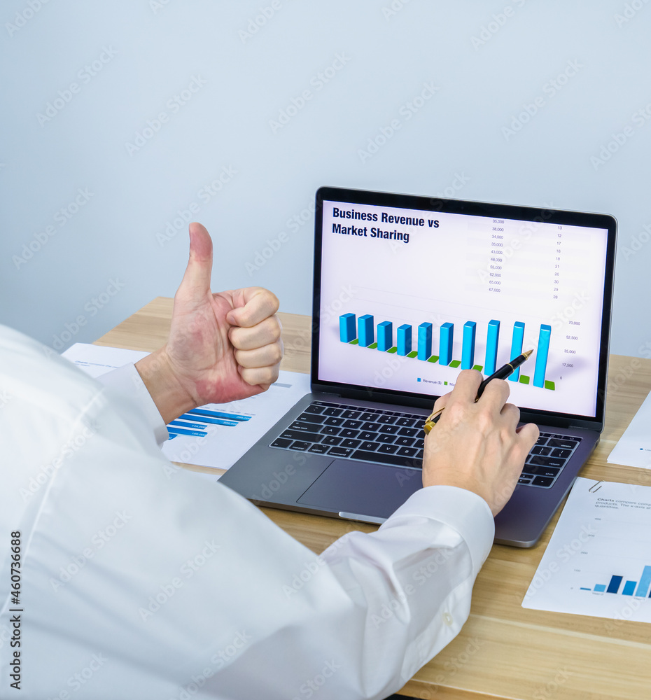 worker give thumb up while present business graph on laptop worker give thumb up while present business graph on laptop
