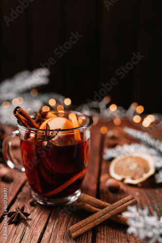 Glass cup of Mulled Wine on wooden table and background. Christmas time concept