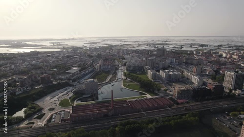 Aerial pull out shot capturing Aveiro city water canal and endless salt flats along the horizon. photo