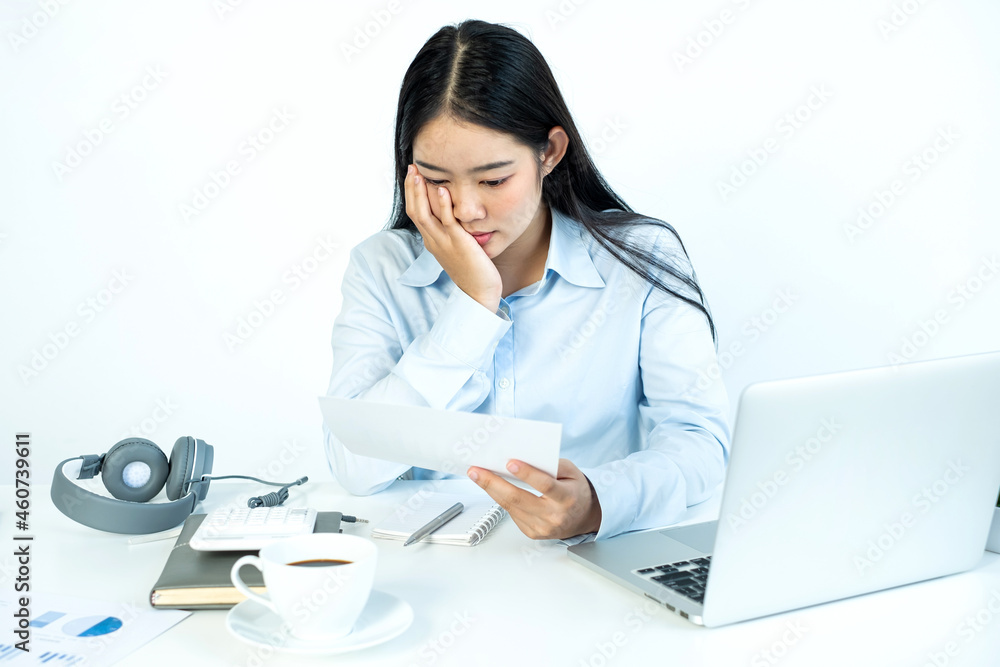 Asian female accountant sits at their desks and calculates financial graphs showing results about their investments, plan a successful business growth process Asian female accountant sits at their desks and calculates financial graphs showing results about their investments, plan a successful business growth process