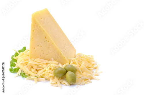 A piece of hard yellow cheese with olives in close-up, isolated on a white background