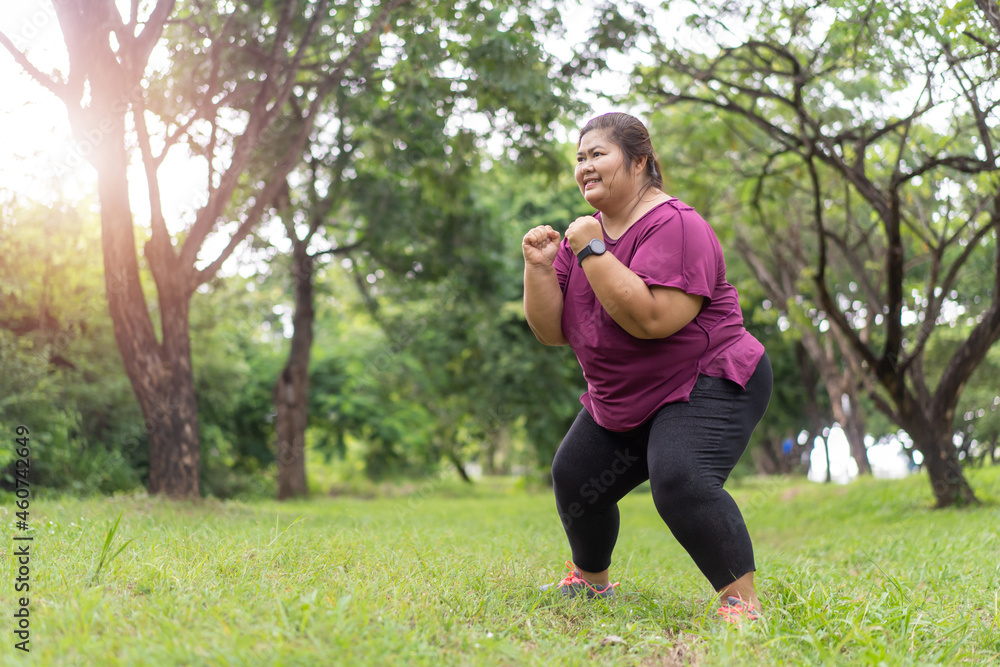 Asian fat woman workout outdoors exercising in park while listening to music, Sport and recreation for weight loss idea concept.