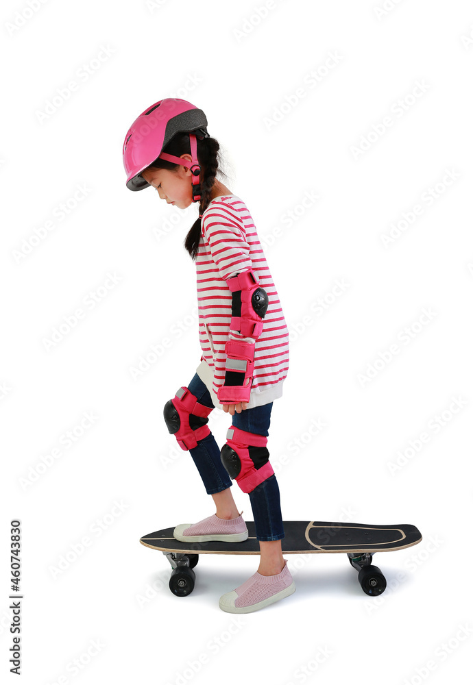 Asian little girl child skating on skateboard isolated over white background. Kid riding on skateboard. Asian little girl child skating on skateboard isolated over white background. Kid riding on skateboard.