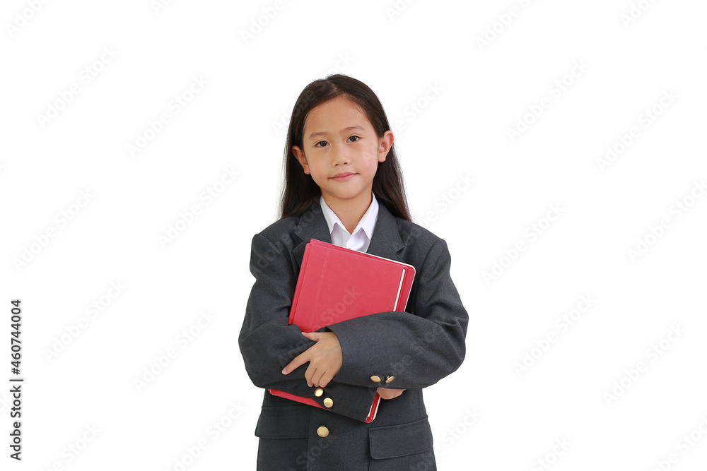 Little Asian schoolgirl in formal wear shirt, business suit hugging a book while looking at camera isolated over white background. Little Asian schoolgirl in formal wear shirt, business suit hugging a book while looking at camera isolated over white background.
