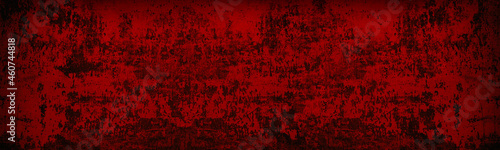 Old peeling paint surface wide texture. Bloody red wall. Dark scarlet colored gloomy backdrop. Abstract grunge sinister background