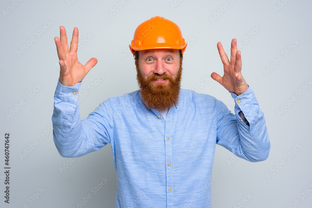 Isolated happy architect with beard and orange helmet