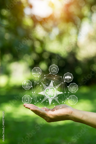 Technology, hand holding with environment Icons over the Network connection on green background