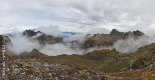 Alpine panorama with clouds in the valleys
