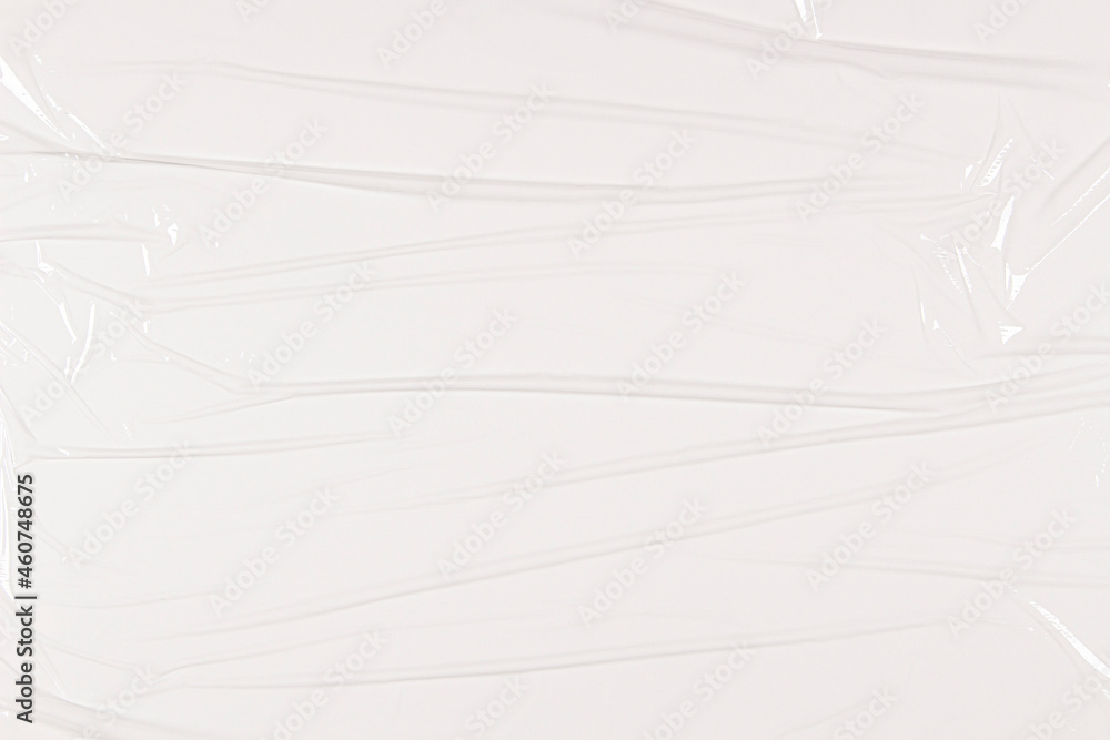Transparent film cellophane background. White wrinkled stretched plastic texture background Transparent film cellophane background. White wrinkled stretched plastic texture background