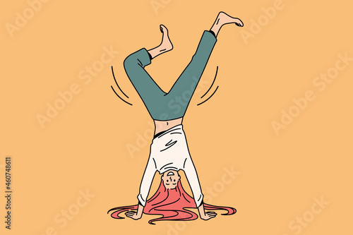 Acrobatics and feeling positive concept. Young positive girl cartoon character standing balancing on hands barefoot over yellow background vector illustration 