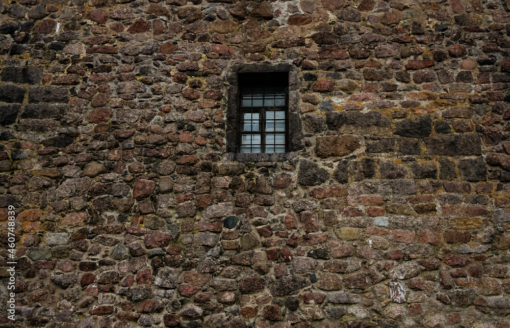 Old stone wall with iron grille and wooden window frame. exterior ...
