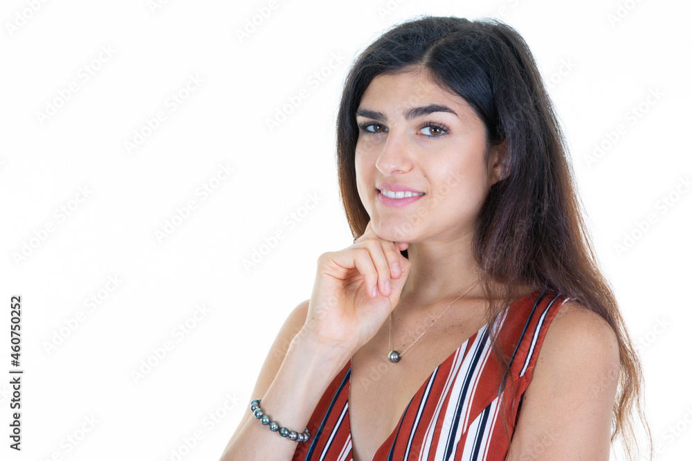 young happy woman smiling and thinking hand finger on chin on white background looking camera