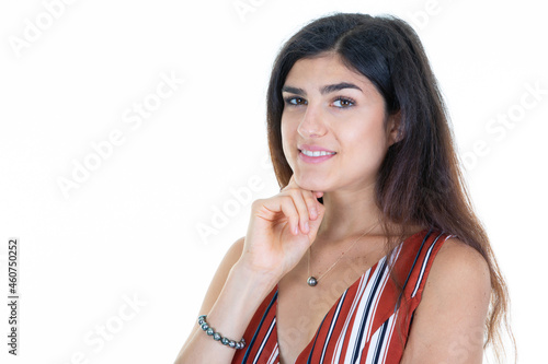 young happy woman smiling and thinking hand finger on chin on white background looking camera