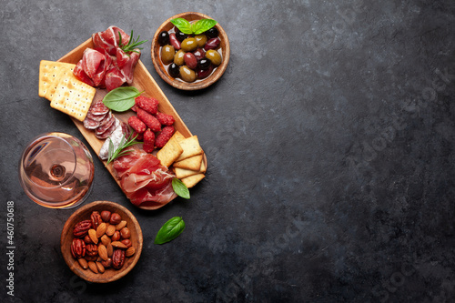 Antipasto board with prosciutto, salami, crackers, cheese, olives