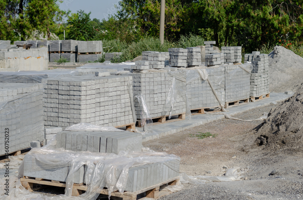 Construction industry. Lots of Pallets of gray paving tiles. New