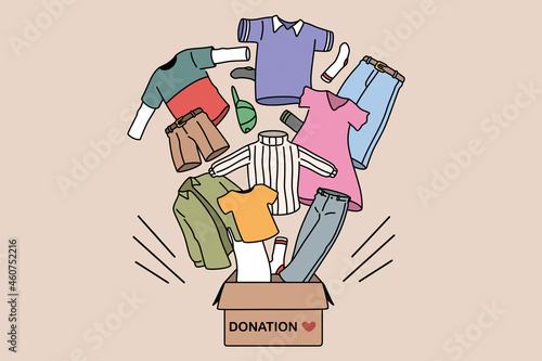 Charity and donating clothes concept. Box with donation word and carious human clothes flying from it for needing people vector illustration 