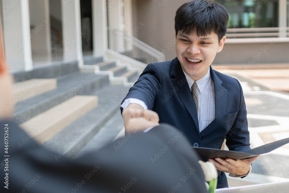 Businessman concept two businessmen touching fists showing harmony when finishing on working on the company project together Businessman concept two businessmen touching fists showing harmony when finishing on working on the company project together