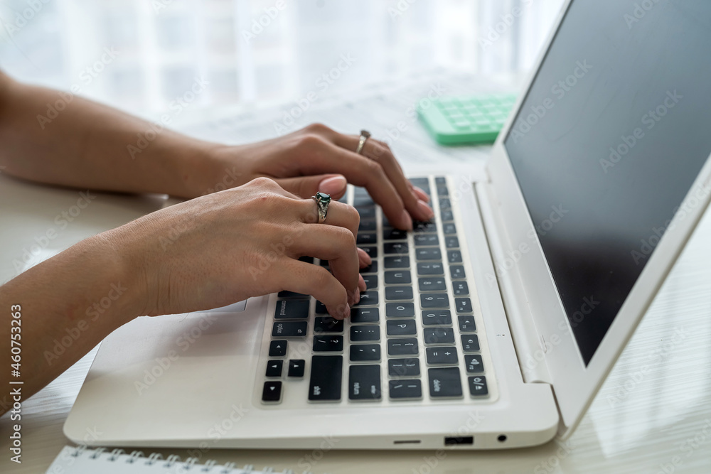 Female hands typing on laptop keyboard close up . Female hands typing on laptop keyboard close up .