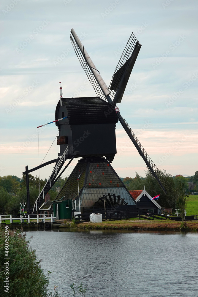Fototapeta premium A proof of Dutch engineering in the 17th century, a windmill to pump the water out of the land. UNESCO world heritage site.