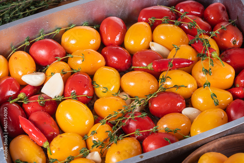 Slika na platnu Cooking homemade confit - colorful cherry tomatoes with garlic, pepper and thyme