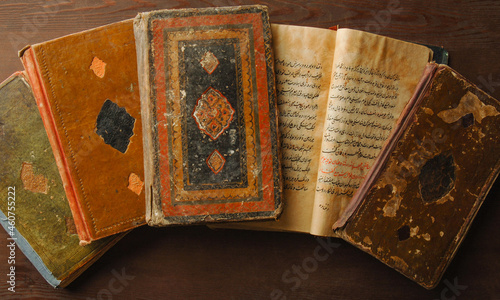 Stack of open ancient books in Arabic. Old Arabic manuscripts and texts. Top view