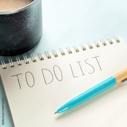To do list, square shpt. A paper notepad with coffee and a turquoise blue pen. The concept of planning, time management etc photo