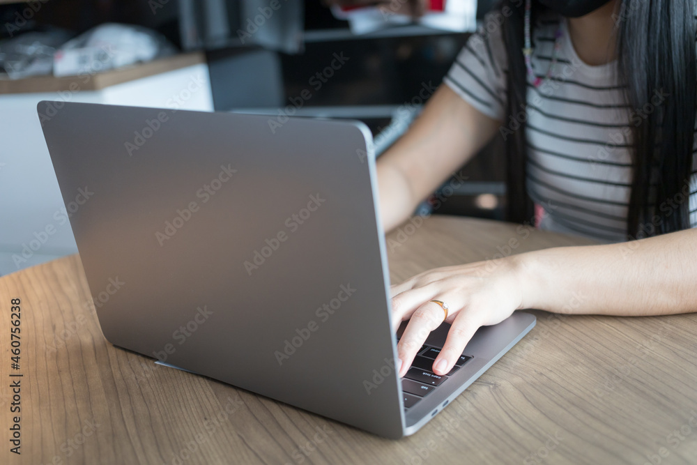 Working from home on laptop while typing chat to customer communicates on internet in home office Working from home on laptop while typing chat to customer communicates on internet in home office