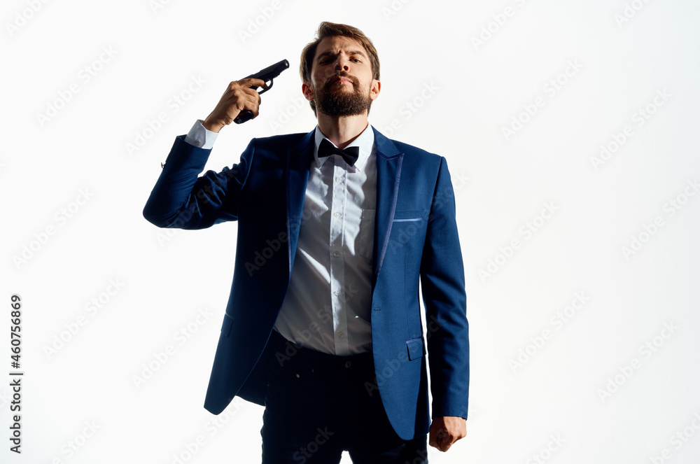 Fototapeta premium Man with a pistol in hand crime detective killer light background