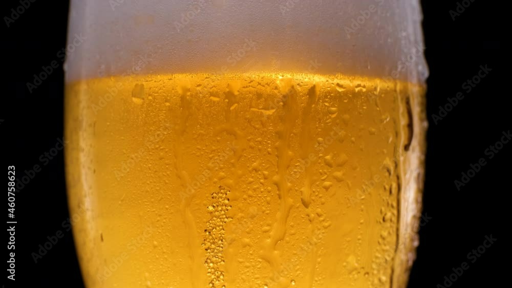 Beer glass with falling water drops. Refreshing and cold beer in a beer glass Beer glass with falling water drops. Refreshing and cold beer in a beer glass