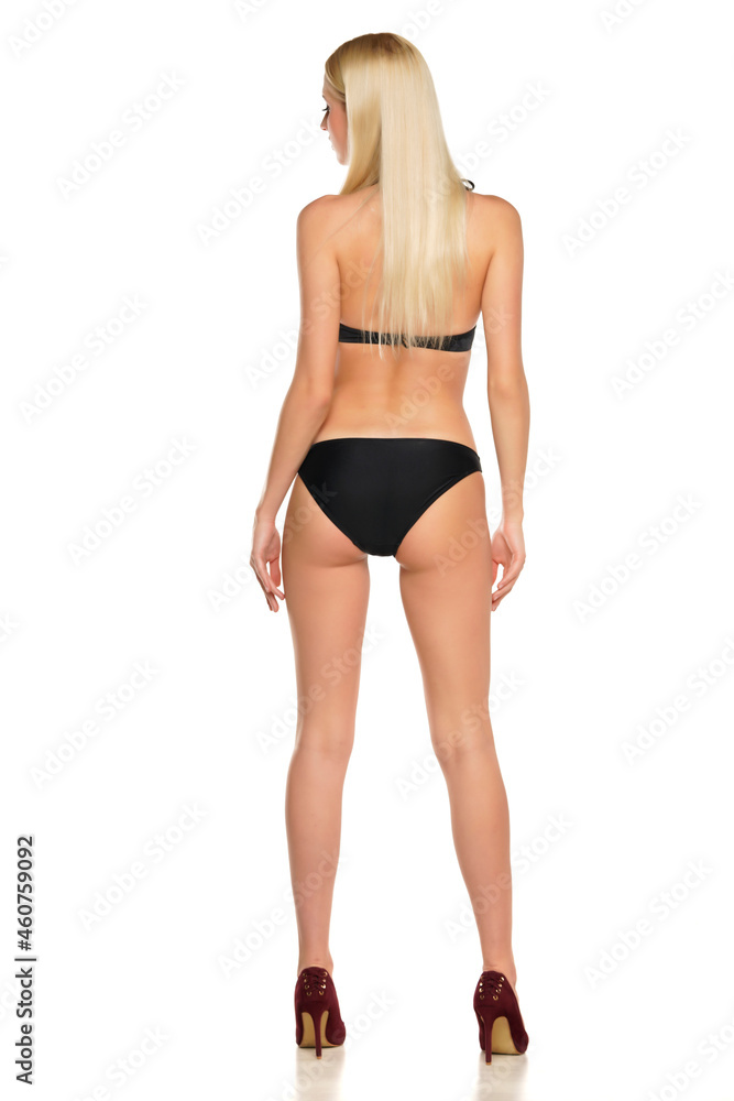 Rear view of a young blond woman posing in swimsuit Rear view of a young blond woman posing in swimsuit