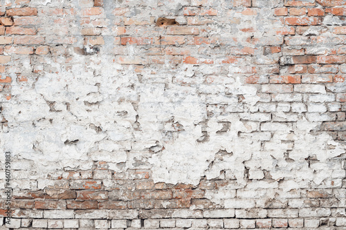 Texture of damaged old brick wall with weather worn surface as background