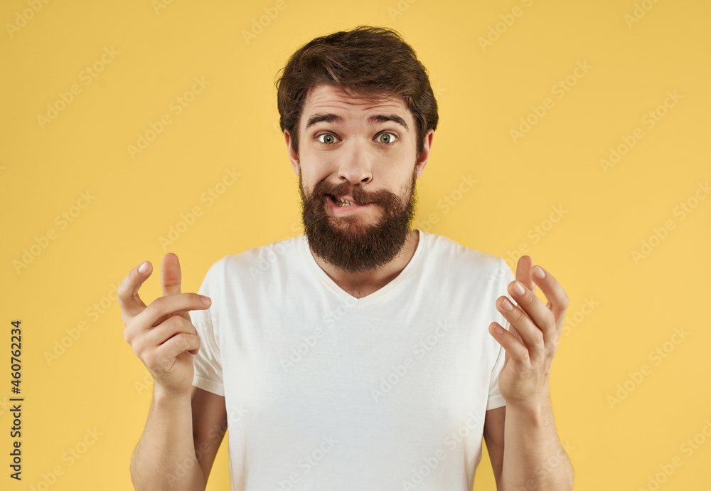 bearded man in white t-shirt gesture with hands studio yellow background bearded man in white t-shirt gesture with hands studio yellow background