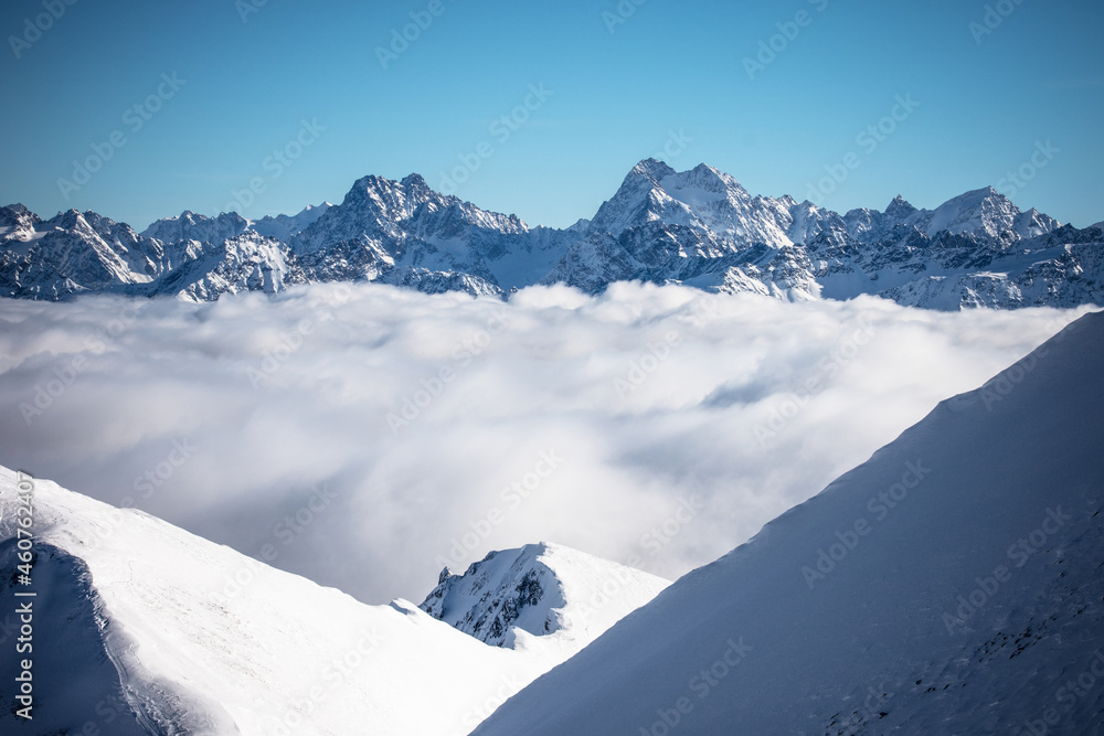 Snow covered mountains in the clouds