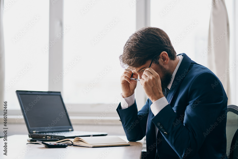 businessmen sitting at a desk in front of a laptop stress anger technologies businessmen sitting at a desk in front of a laptop stress anger technologies
