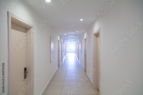 Long corridor with doors in building.