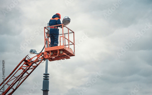 Quadro em tela Street light repair works, worker repair street lamp at height, led lights replacement